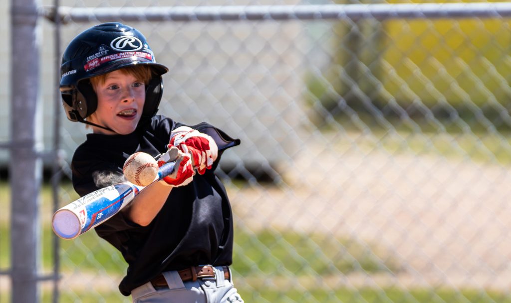 Minor baseball player taking a crack at bat is one of the thousands of Images from 1984 and a Kim Mitchell concert are among the shots we've taken doing Event and Sports Photography shots we've taken at Soaring Pig Studios.