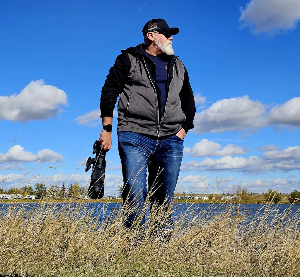 Photographer Stephen Dafoe walks with his camera. 