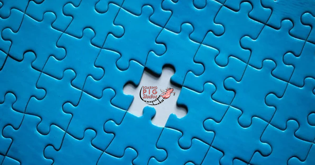 Puzzle with a missing piece filled with Soaring Pig Studios logo. We are the missing piece from your communications and marketing strategy.