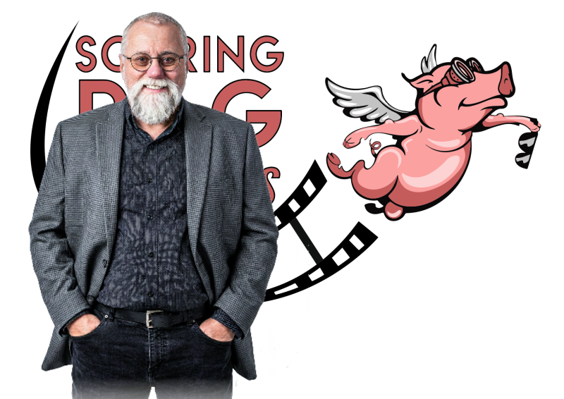 Soaring Pig Studios owner Stephen Dafoe in front of the company logo